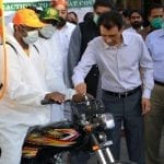 Khalid Maqbool Siddiqui distributes motorcycle keys for spray campaign
