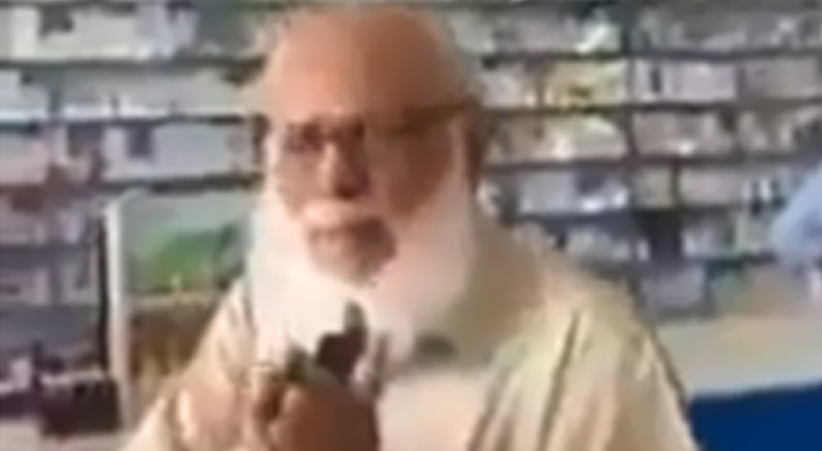 Elderly man embarrasses a woman in market