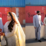 Couple poses for wedding shoot in front of containers in islamabad